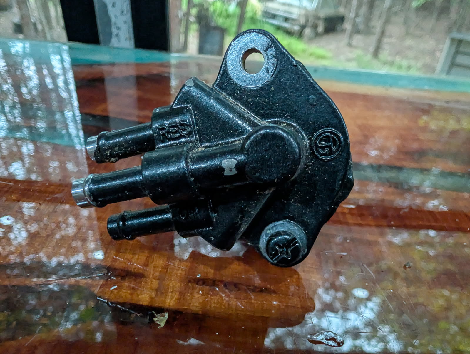 Jet ski fuel selector valve front view showing TRS marking and barbed fittings