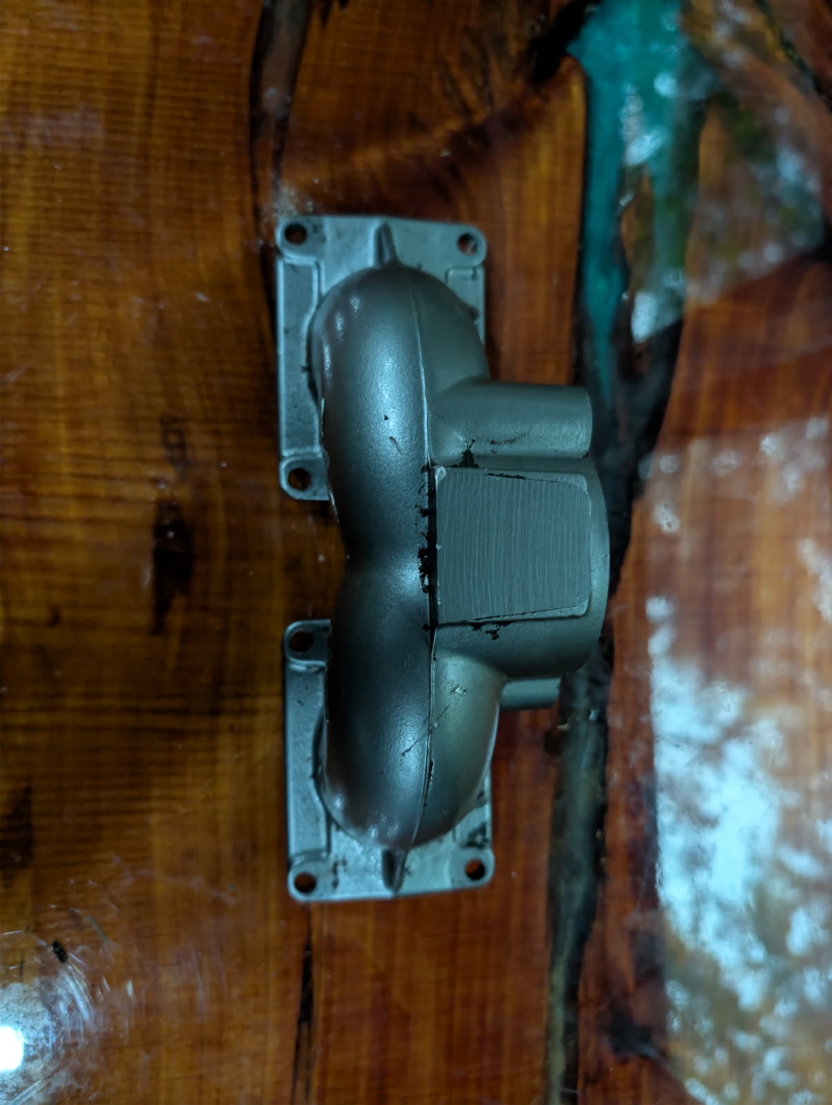 Kawasaki 650 intake manifold side view showing dual rectangular reed valve ports