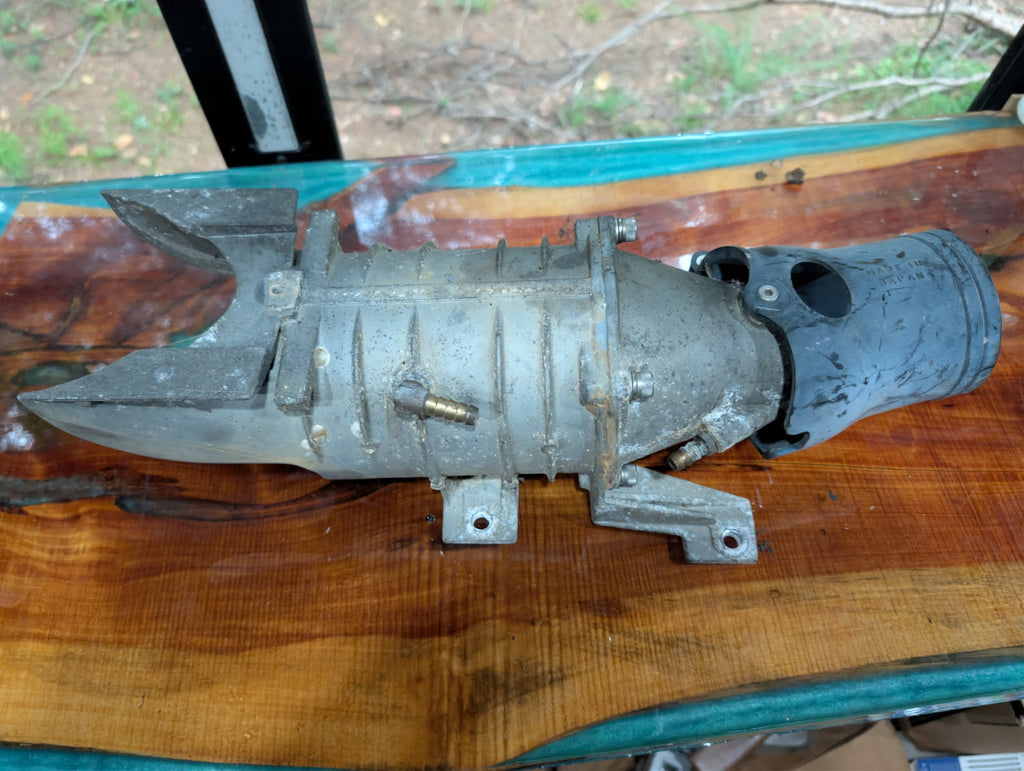 Yamaha Wave Raider jet pump housing assembly side view showing intake grate and fittings