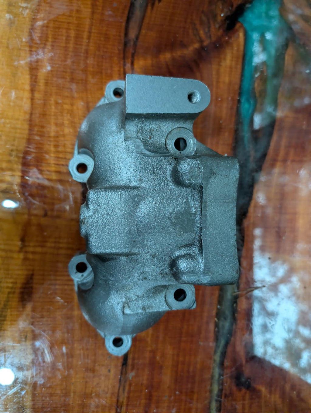 Kawasaki 750 exhaust manifold top view showing mounting flanges and water port