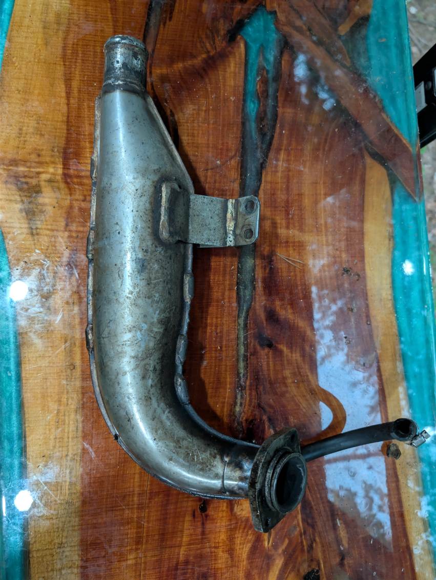 Kawasaki JS550 exhaust manifold header pipe - front view showing inlet flange and water fitting