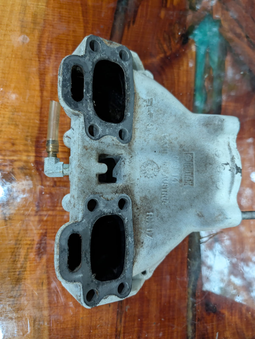 Sea-Doo 717 Rotax exhaust manifold bottom view showing cylinder ports and casting marks