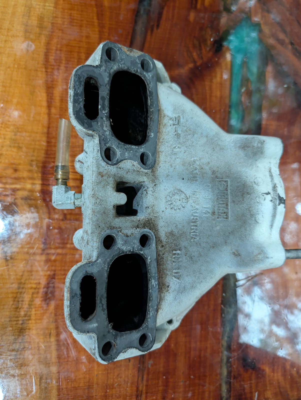 Sea-Doo 717 Rotax exhaust manifold bottom view showing cylinder ports and casting marks